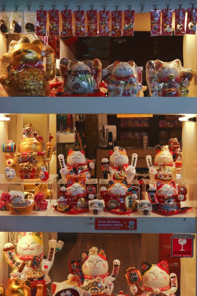 A display of colourful lucky cat figurines in a shop in Kuala Lumpur, symbolising good fortune and prosperity