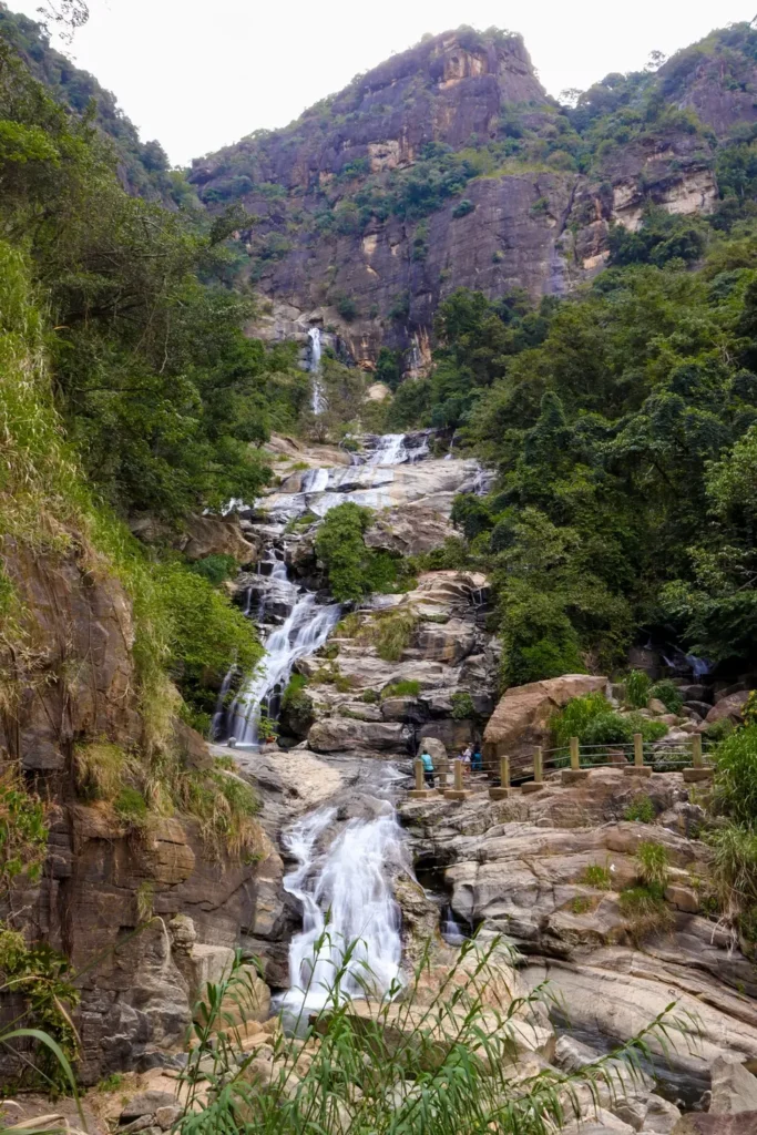 A stunning view of Ravana Falls cascading down rocky terrain surrounded by lush greenery, one of the top things to do in Ella