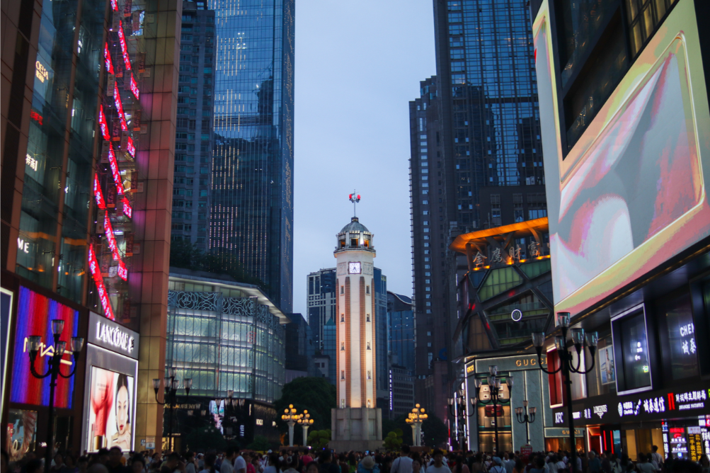 2 weeks in China: the perfect first-timer itinerary for an unforgettable trip 34 Jiefangbei (Liberation Monument) plaza at dusk, surrounded by high-end stores and glass skyscrapers in Chongqing’s bustling central business district.