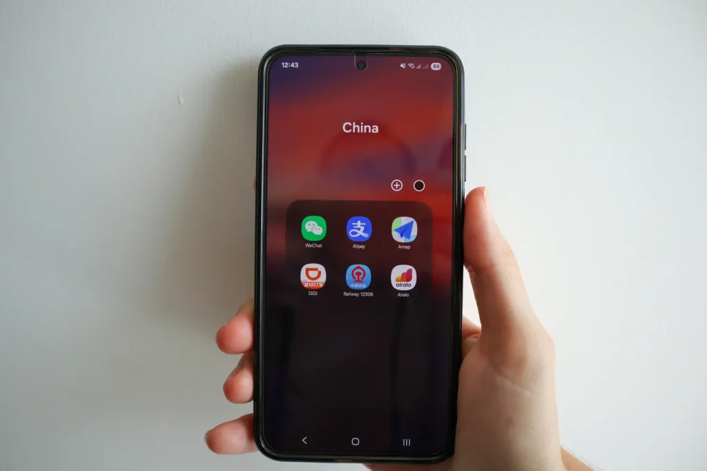 9 Essential Apps you need in China in 2026 9 Home screen folder labeled “China” containing essential apps like WeChat, Alipay, Amap, Didi, Railway 12306, and Airalo. A snapshot of top apps you need in China for communication, transport, and travel logistics.