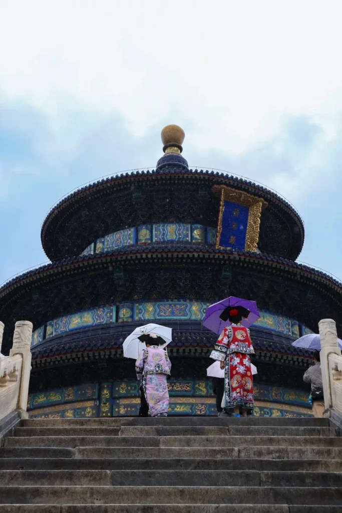 Unforgettable 3 Days in Beijing: the perfect itinerary (+map) 21 Tourists wearing traditional Hanfu and holding umbrellas walk up the stone steps to the Temple of Heaven in Beijing